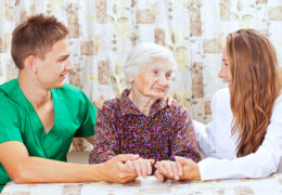 Young man and woman assisting the old woman